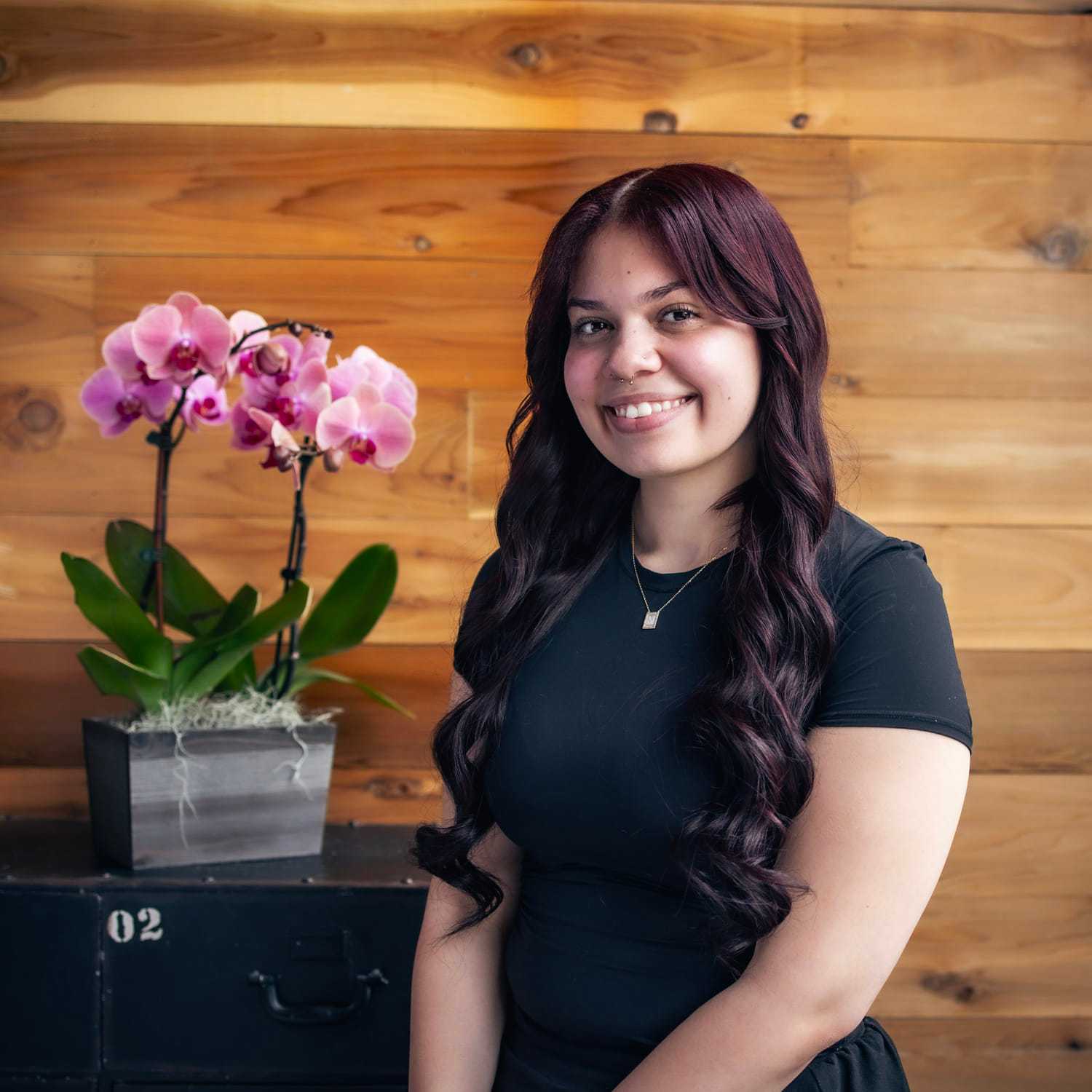 Portrait of Anna, a professional stylist at Salon Paul Michael, showcasing their expertise and style.