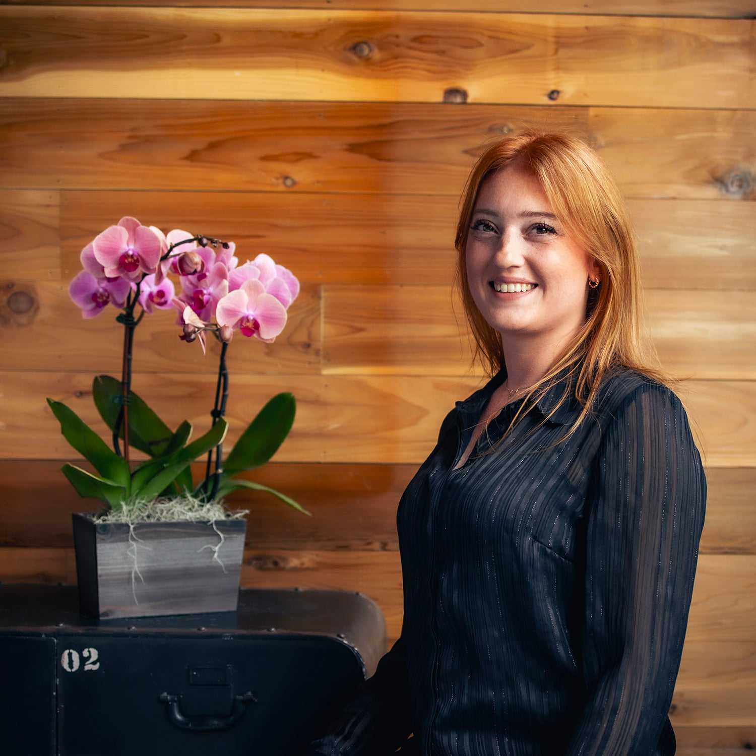 Portrait of Allie, a professional stylist at Salon Paul Michael, showcasing their expertise and style.