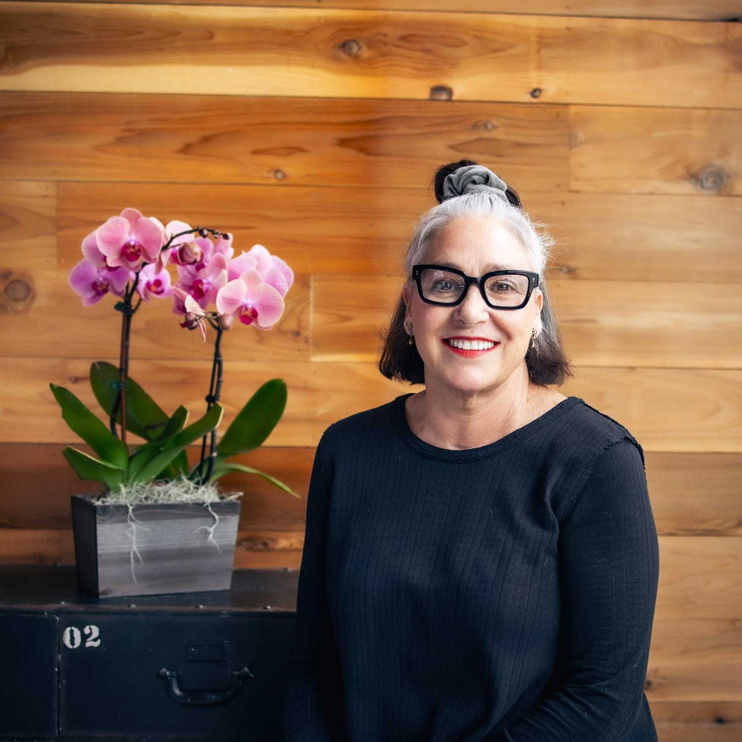 Portrait of Dorothy, a professional stylist at Salon Paul Michael, showcasing their expertise and style.