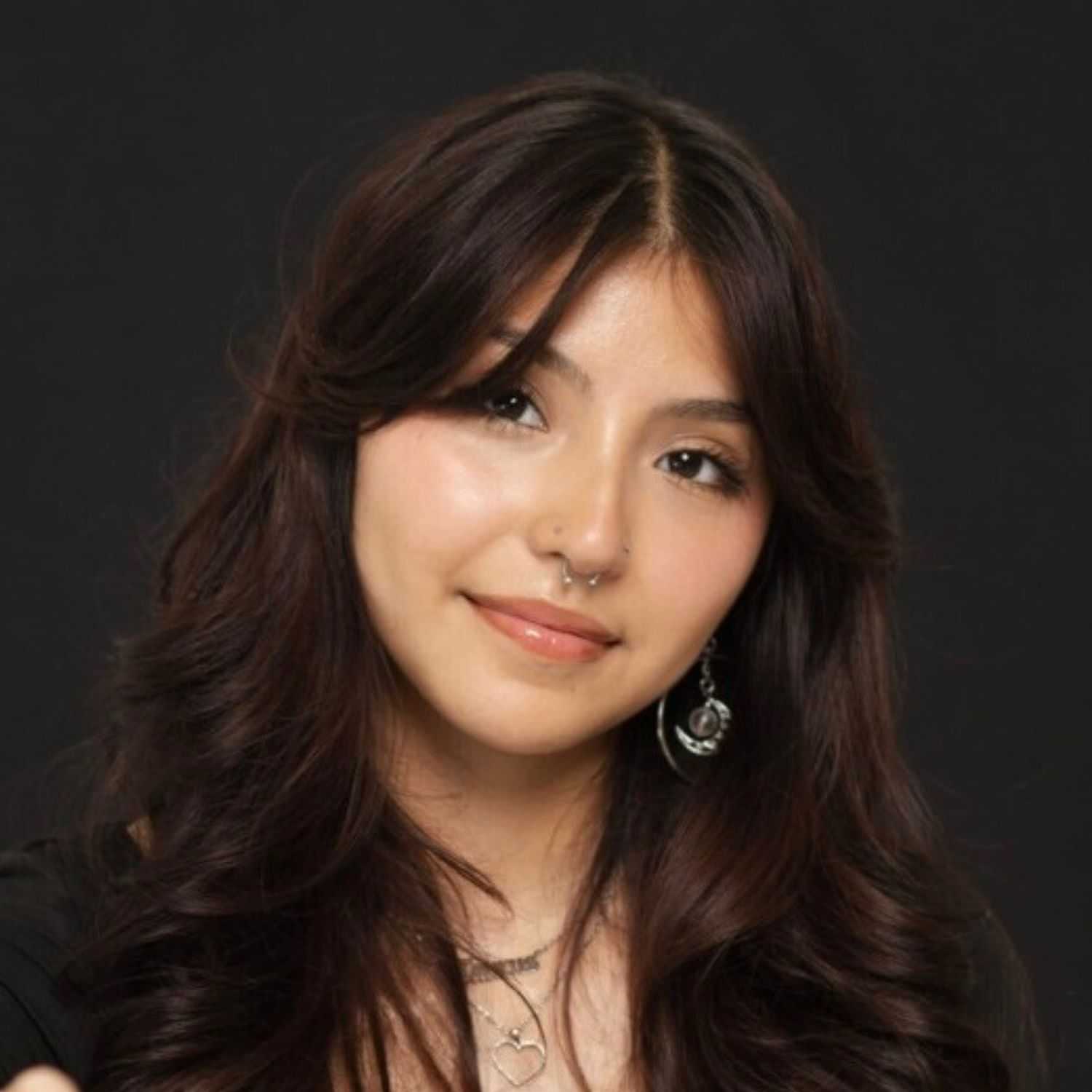 Portrait of Isabella, a professional stylist at Salon Paul Michael, showcasing their expertise and style.