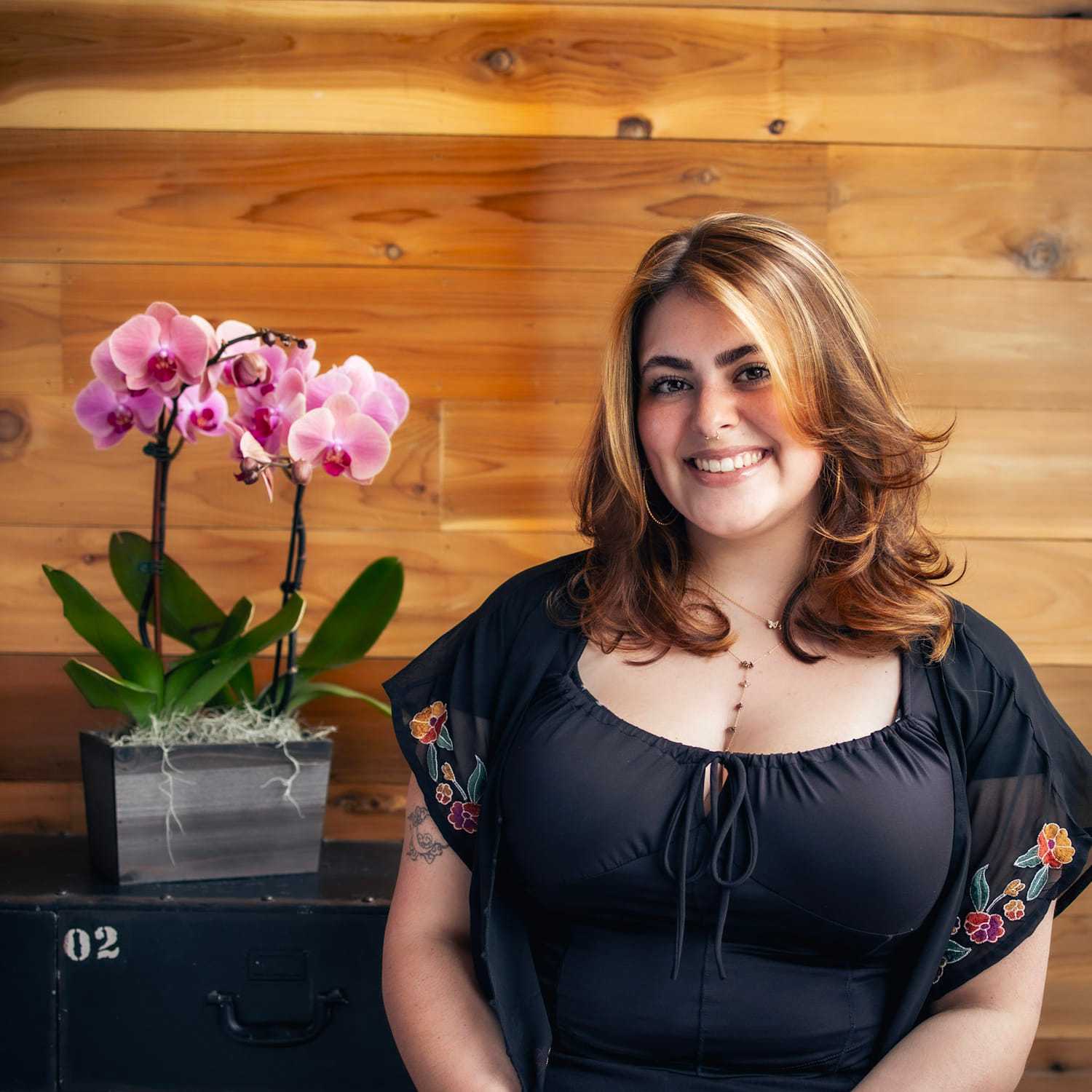 Portrait of Sara, a professional stylist at Salon Paul Michael, showcasing their expertise and style.