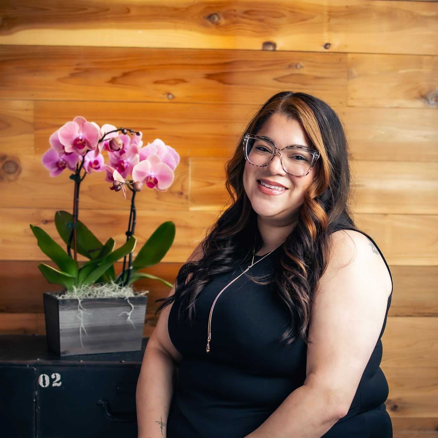 Portrait of Crystal, a professional stylist at Salon Paul Michael, showcasing their expertise and style.