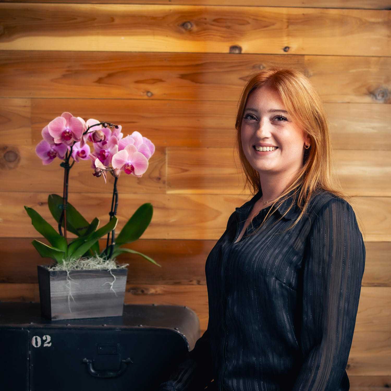 Portrait of Allie, a professional stylist at Salon Paul Michael, showcasing their expertise and style.