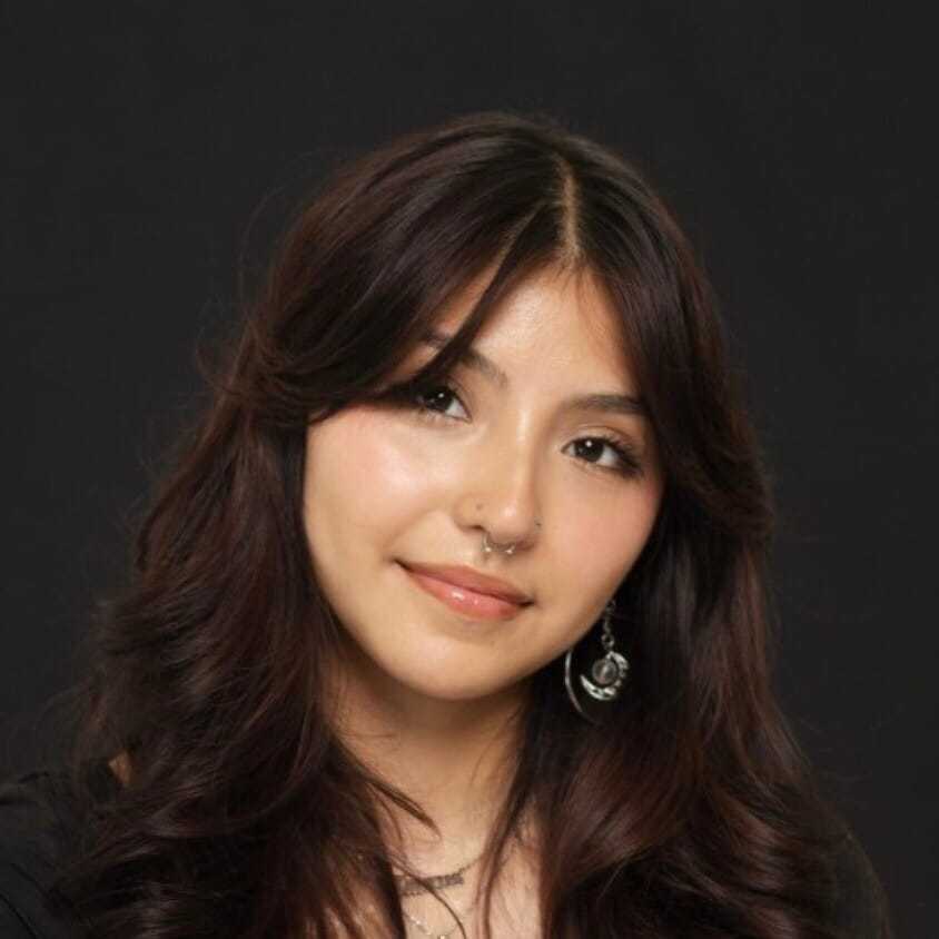 Portrait of Isabella, a professional stylist at Salon Paul Michael, showcasing their expertise and style.