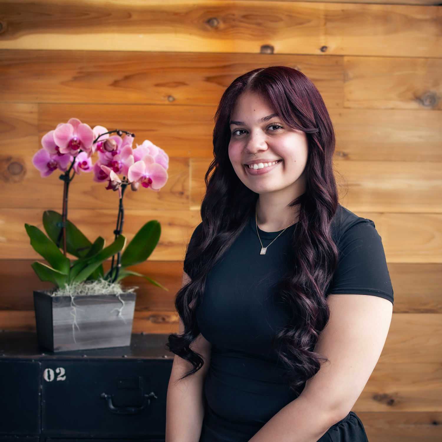 Portrait of Anna, a professional stylist at Salon Paul Michael, showcasing their expertise and style.