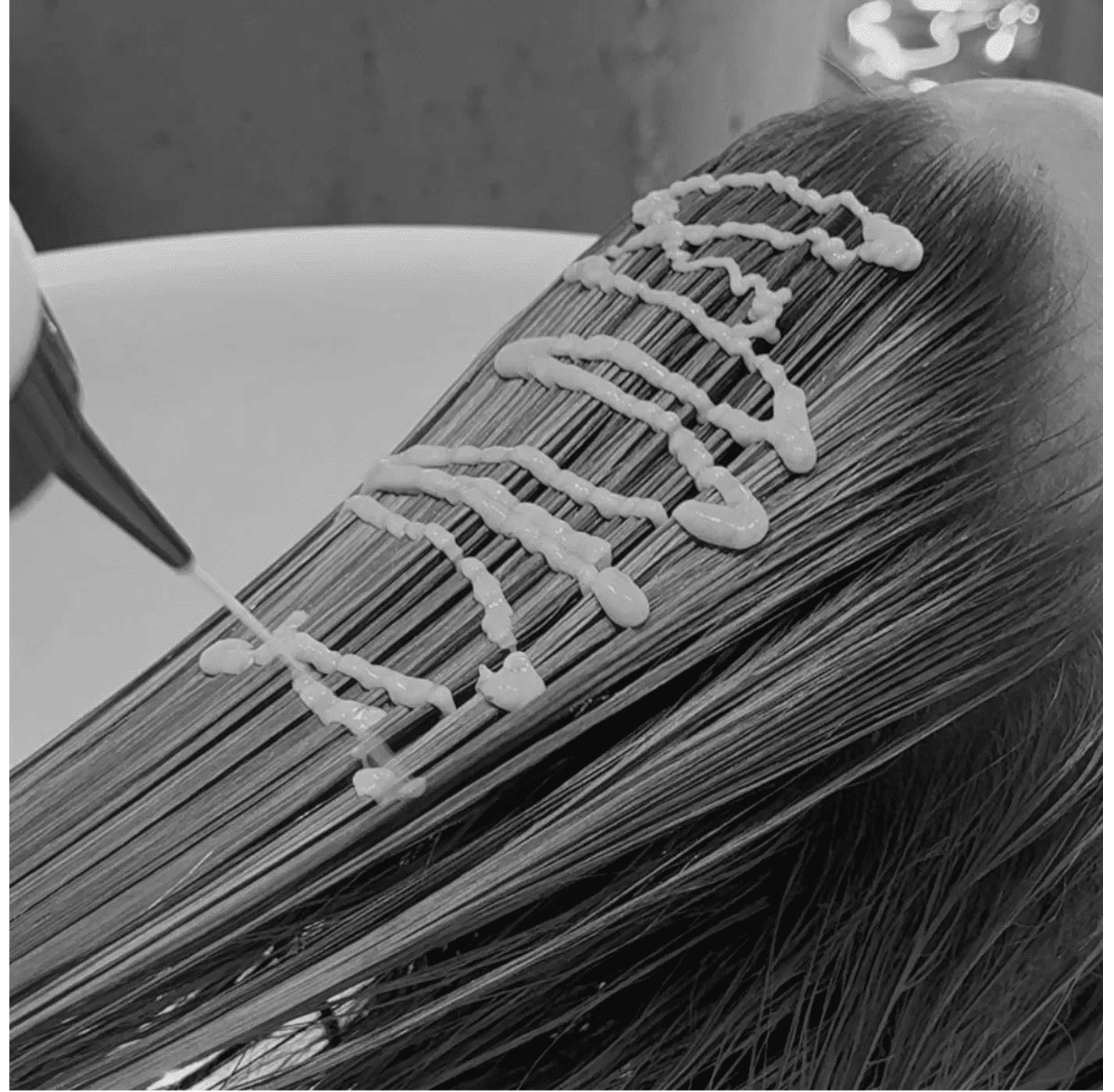 Hair receiving treatment, product applied in zigzag pattern.